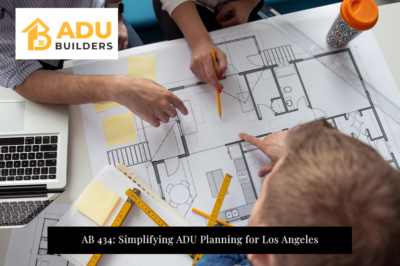 ADU layout plan on desk with team discussing AB 434 guidelines for Los Angeles